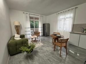a living room with a green couch and a table at Serenity villa in Pointe aux Biches