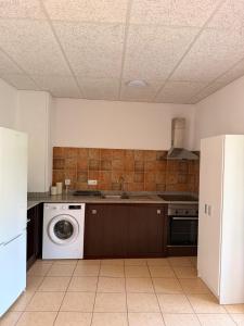 a kitchen with a sink and a washing machine at La Sabonnera in Sant Llorenç de la Muga +27 photos