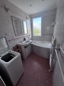 a bathroom with a tub and a sink and a bath tub at 3 room apartment in Trnava +8 photos