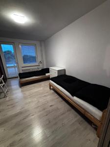 a bedroom with a bed and a desk and two windows at 3 room apartment in Trnava