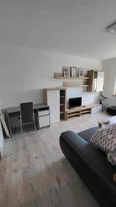a living room with a couch and a desk at 3 room apartment in Trnava