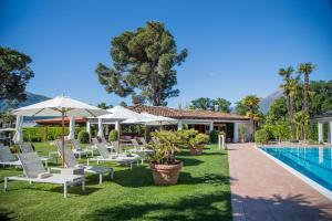 a group of chairs and umbrellas next to a pool at Appartement Rosalia Delta Resort 741 in Ascona