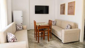 a living room with a couch and a table at Vila Tirona in Durrës
