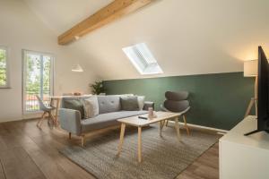 a living room with a couch and a table at Ferienwohnung Marla in Eriskirch