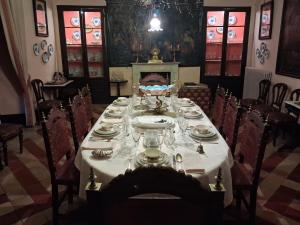 a long table with plates and glasses on it at Hotel Ordóñez Sandoval in Úbeda