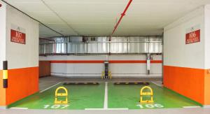 a room with a basketball court and two yellow chairs at Hotel Pupin Novi Sad in Novi Sad