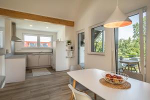 a kitchen with a table with a bowl of fruit on it at Ferienwohnung Marla in Eriskirch
