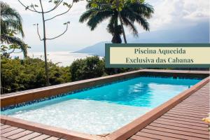 a swimming pool in a villa in kuta australia at Tahaa Pousada Boutique in Ilhabela