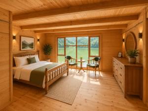 a bedroom with a bed and a table with chairs at Buneba Resort in Borçka