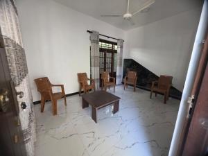 a room with chairs and a table and a window at Villa at 37 in Badulla