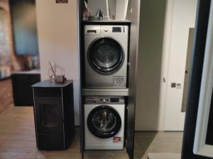 two washing machines and a washer and dryer in a room at Kipsala Cozy Apartment in Riga