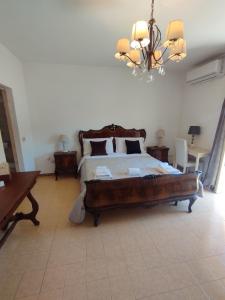 a bedroom with a large bed and a chandelier at Petalo Rosso b&b in Lenola +265 photos