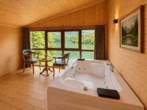 a large bath tub in a room with a table at Buneba Resort in Borçka +29 photos