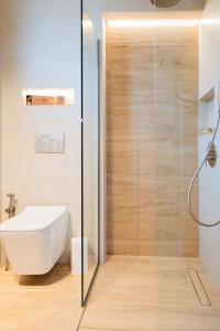 a bathroom with a toilet and a shower at Ligaries in Kini +64 photos