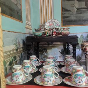 a group of tea cups and saucers on a table at Hotel Ordóñez Sandoval in Úbeda +55 photos