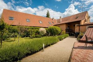 a house with a pathway in front of a yard at Penzion Miromar in Podivín