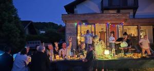a man standing on top of a table with a group of people at Basel Landskron Haus in Leymen