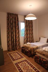 a bedroom with two beds and a window at Lala Resort in Kolgecaj +55 photos