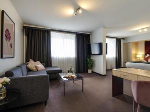 a living room with a couch and a table at Mercure Albury in Albury
