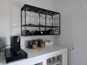 a room with a counter with glasses on a shelf at Apartment Čebelica in Lesce +6 photos