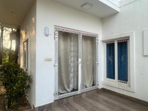 an empty room with a window with curtains on it at Waves - for Family & Married Couples only in Mahabalipuram