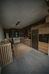 a large kitchen with a refrigerator and a counter at Sky Line Villa in Ardeşen