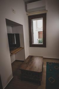 a living room with a coffee table and a window at Calliοpe's home in Skiathos
