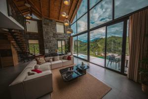 a large living room with large windows and a view of the mountains at Sky Line Villa in Ardeşen