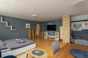 a living room with a bed and a table at Penzion Miromar in Podivín