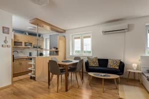 a kitchen and a living room with a table and chairs at Penzion Miromar in Podivín