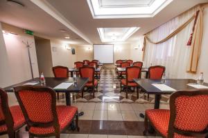 a conference room with tables and chairs and a whiteboard at Rixwell Old Riga Palace Hotel in Riga
