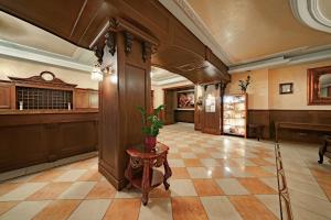 a lobby with a table in the middle of a building at Rixwell Old Riga Palace Hotel in Riga