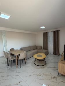 a living room with a couch and a table at Apartmani Kastratovic in Golubovci