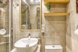 a bathroom with a sink and a toilet at La Pau de Portbou 2 in Portbou