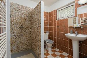 a bathroom with a toilet and a sink at Penzion Miromar in Podivín +47 photos