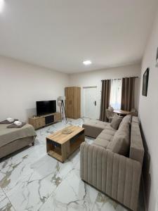 a living room with a couch and a table at Apartmani Kastratovic in Golubovci
