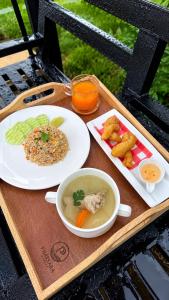 a tray with two plates of food and a bowl of soup at ภัสรา รีสอร์ท in Ban Nong Khla