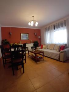a living room with a couch and a table at Burgau Mar in Burgau