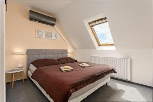 a bedroom with a bed with two towels on it at Penzion Miromar in Podivín