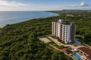 an aerial view of a building next to the ocean at DG Coastal Comfort near Alona Beach - Pool, Gym and Play area in Dauis
