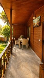 a patio with a table and chairs on a porch at Cirali Camping in Cıralı +57 photos