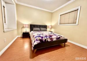 a bedroom with a bed and two lamps in it at 3BR Spacious Living Space 1 Parking Private Entry in Richmond