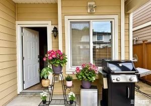 a front porch with potted plants and a grill at 3BR Spacious Living Space 1 Parking Private Entry in Richmond