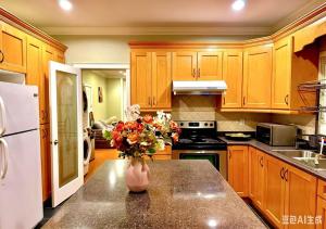 a kitchen with wooden cabinets and a vase of flowers on a counter at 3BR Spacious Living Space 1 Parking Private Entry in Richmond +9 photos