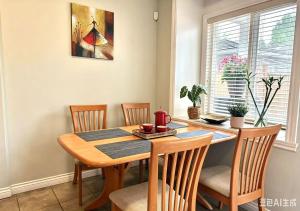 a dining room with a wooden table and chairs at 3BR Spacious Living Space 1 Parking Private Entry in Richmond