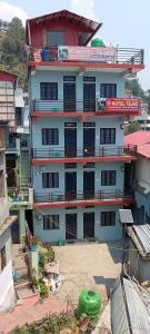 a large white building with a lot of windows at Hotel Tejas in Gupta Kāshi