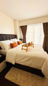 a bedroom with two beds with a table on it at Resort Living 1BR Corner Apartment with Balcony in Maribago +57 photos