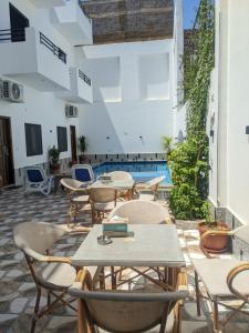 a patio with tables and chairs and a pool at NOOR SEEN House in Luxor