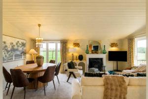 a living room with a table and a couch at The Paddock Lodge in Withcote
