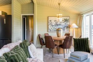 a dining room with a table and chairs at The Paddock Lodge in Withcote +15 photos